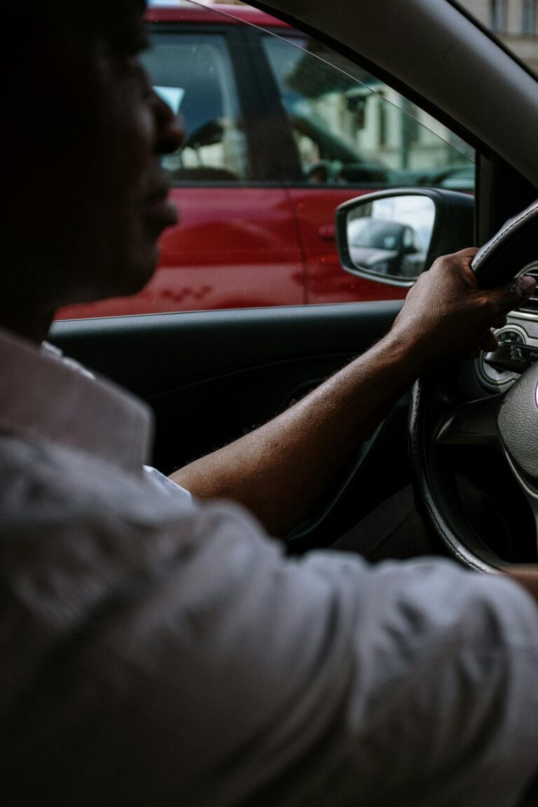 Man in Gray Long Sleeve Shirt Driving Car